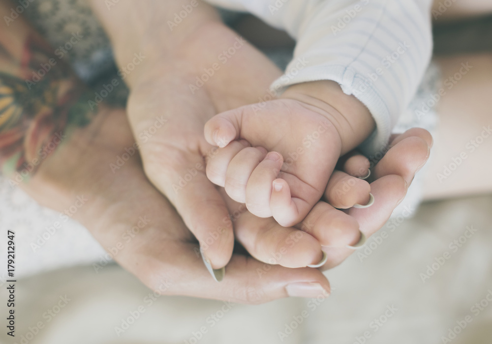 Closeup of family hands holding each other with love