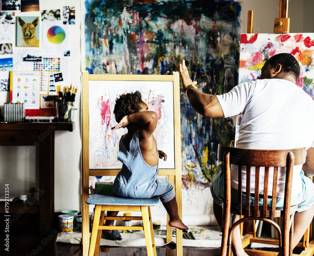 African descent artist dad giving his child a high five