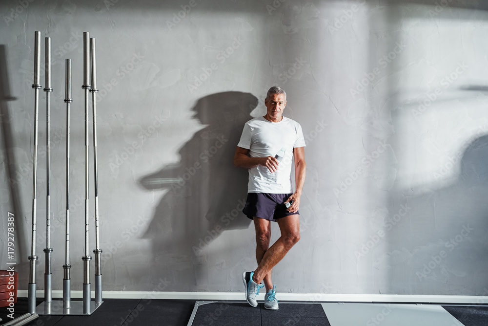 Mature man drinking water after a health club workout