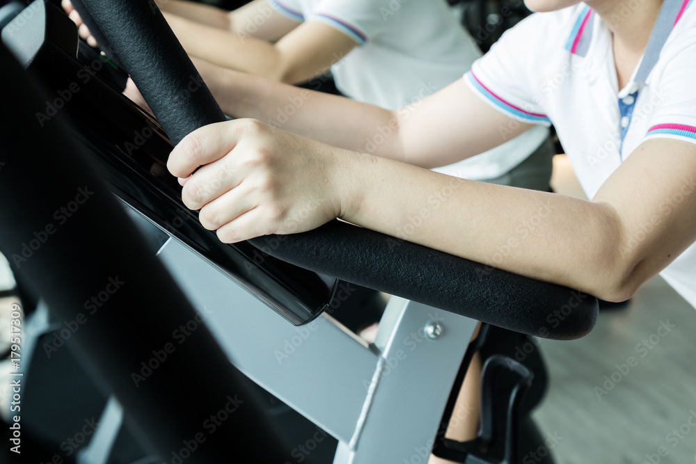 sport and health concept with asian beautiful girl exercise with equipment in fitness room