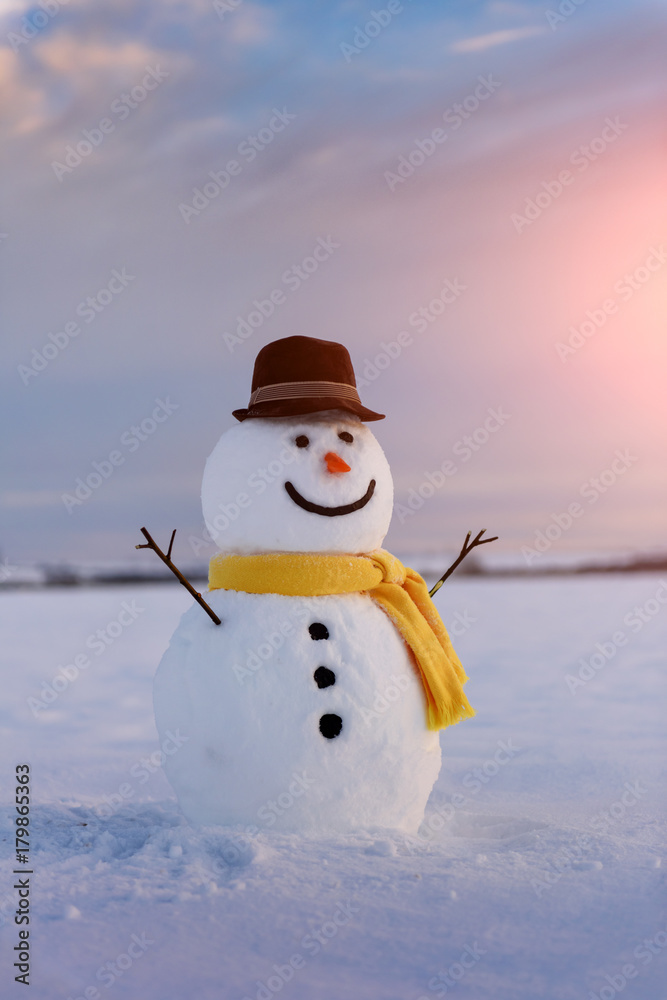 Funny snowman in yellow hat