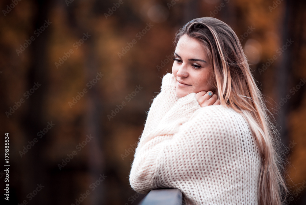 Beautiful woman in sweater enjoy colorful autumn