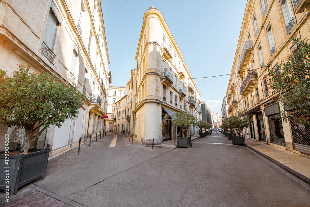 Street view with beautiful old buildings in Nimes city in the Occitanie region of southern France