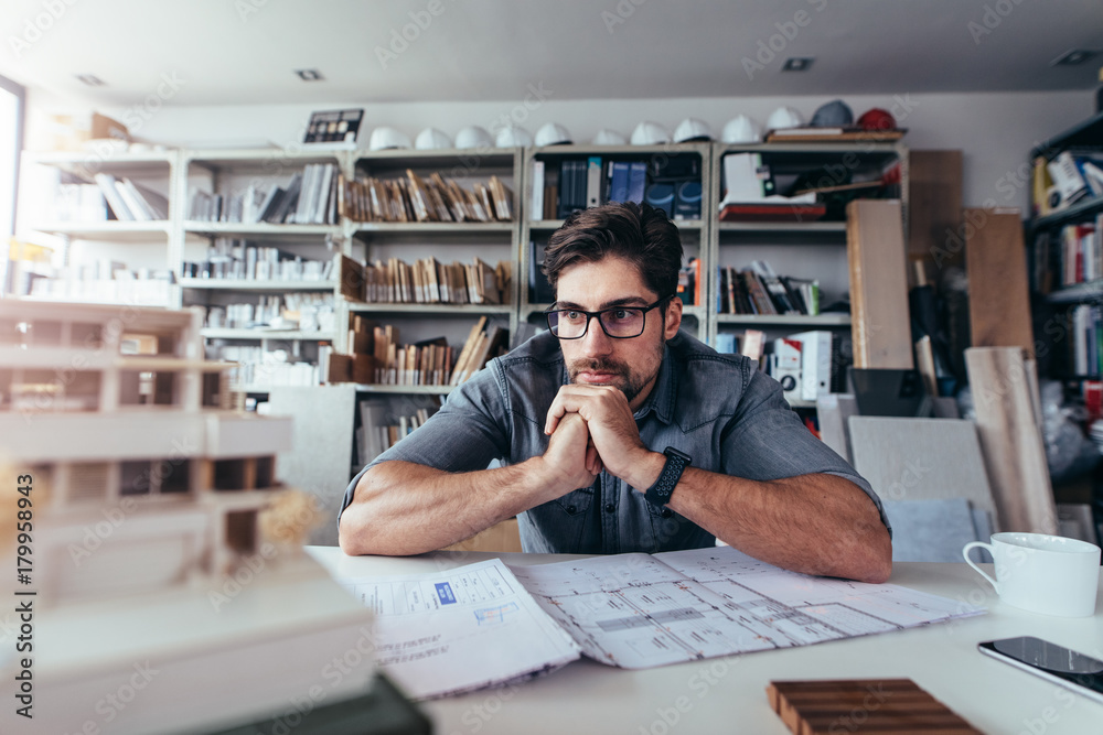 Young architect thinking about new construction ideas