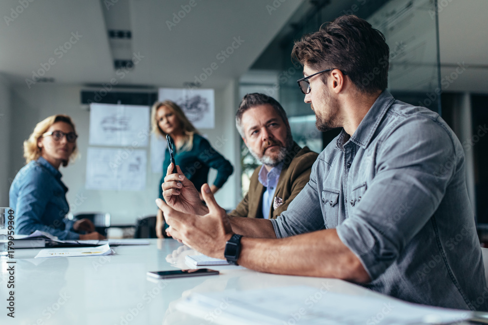 Businessman putting forward his suggestions to team