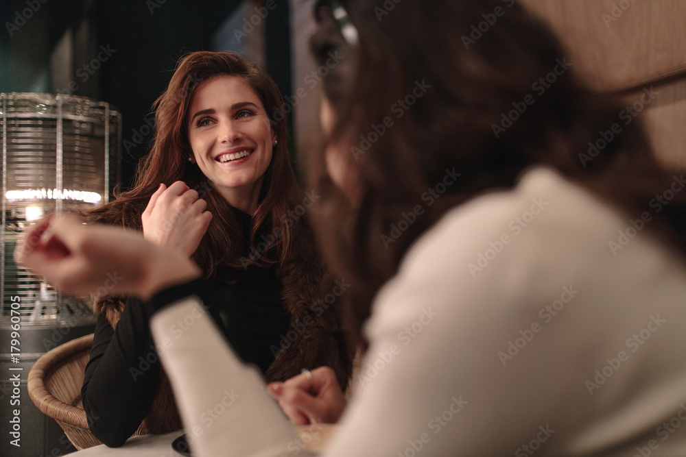 Female friends talking at a coffee shop