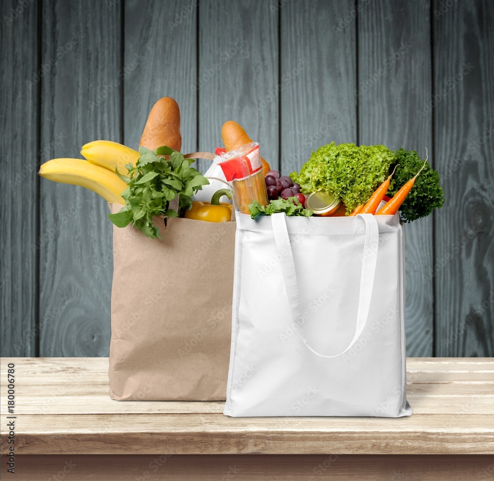 Shopping bags with groceries isolated on white background