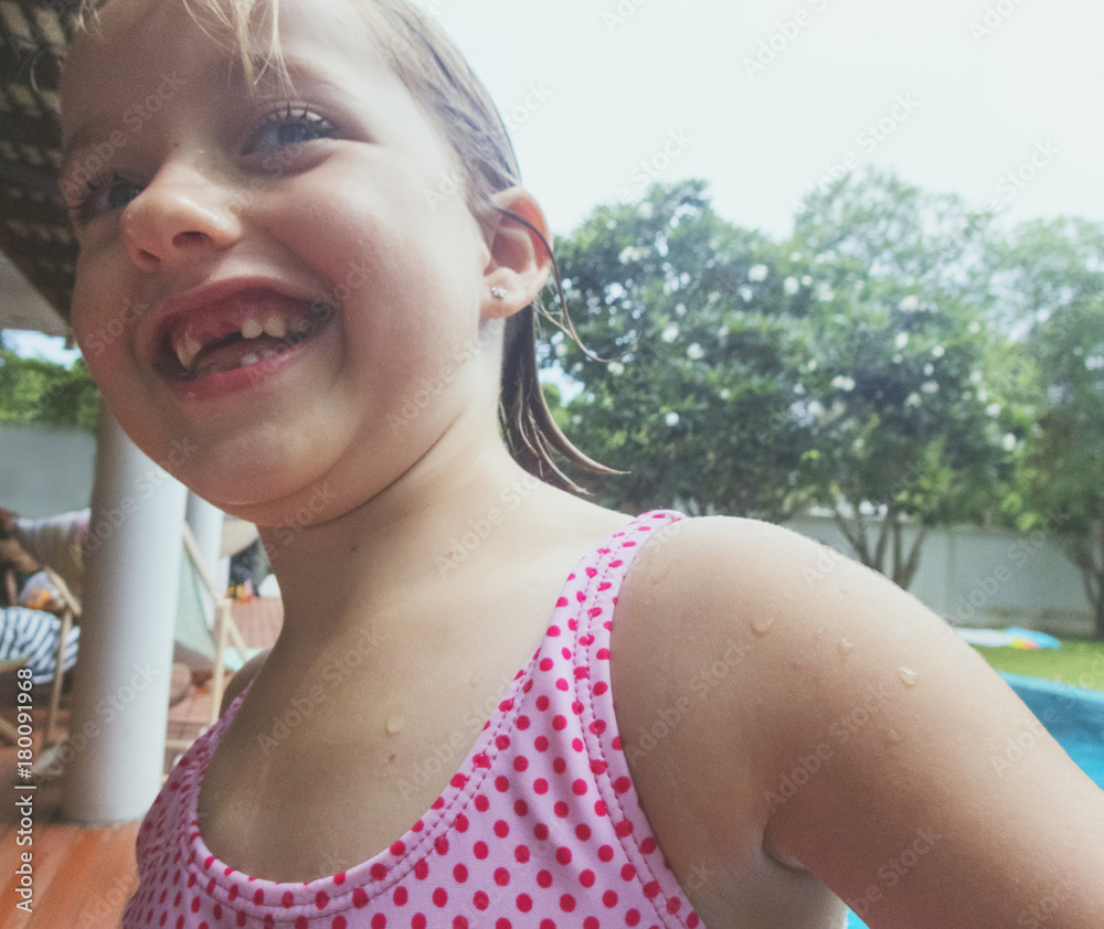 Closeup of caucasian girl standing alone by the pool