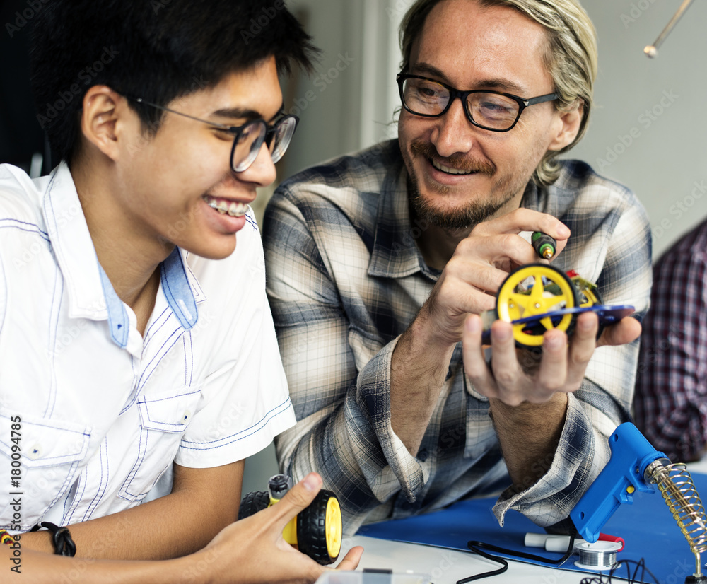 Electrical technicians working on robot electronics parts