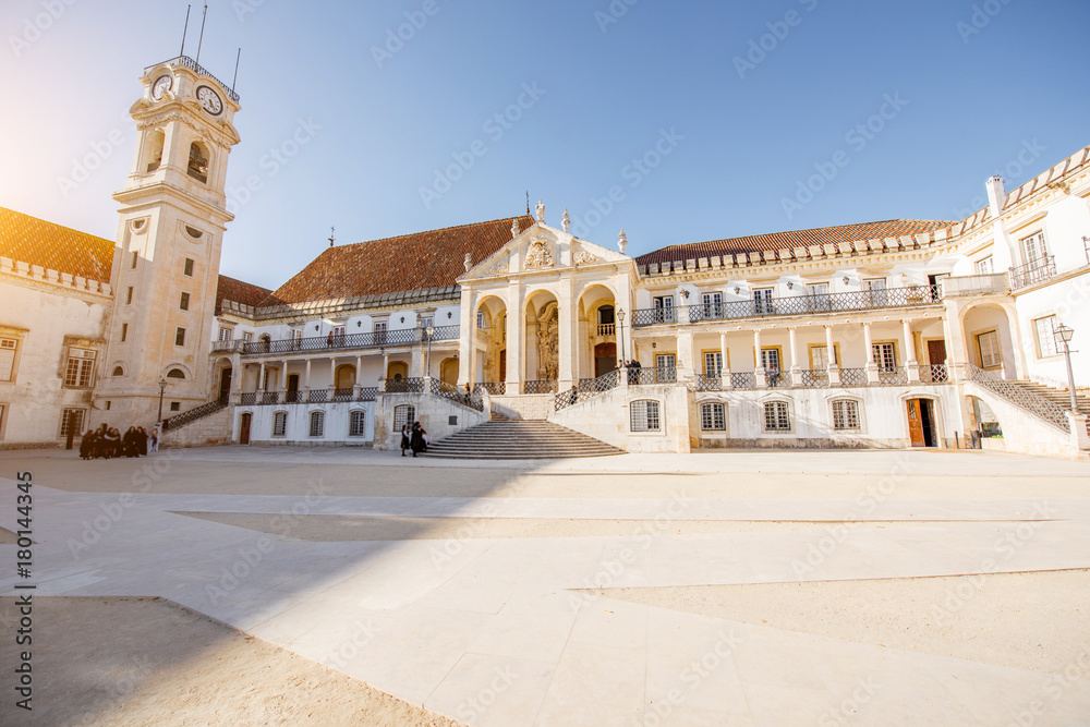 View on the courtyard of the old university with university tower in Coimbra city during the sunset 