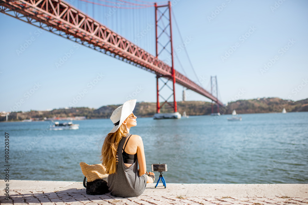 Woman enjoying beautiful landscape view on the famous iron bridge standing back near the river in Li