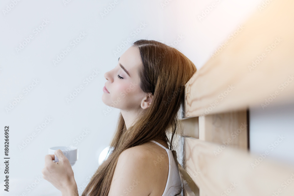 beautiful happiness caucasian girl enjoy morning moment with hot coffee in white tshirt with light f