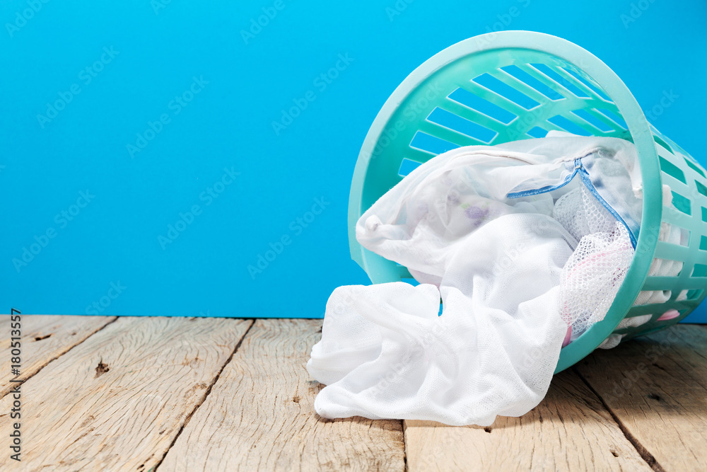 laundry basket of clothes on wooden