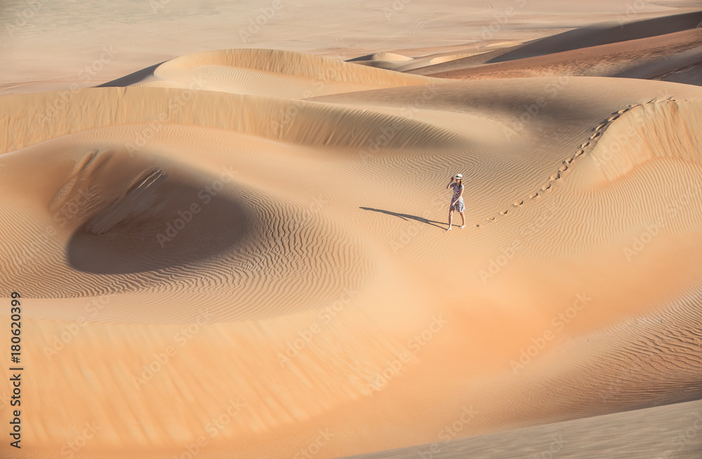 Young woman walking around desert.