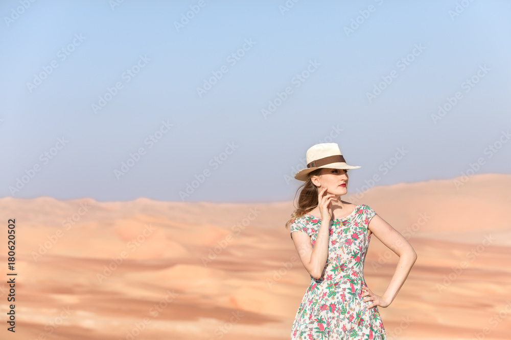 Young woman walking around desert.