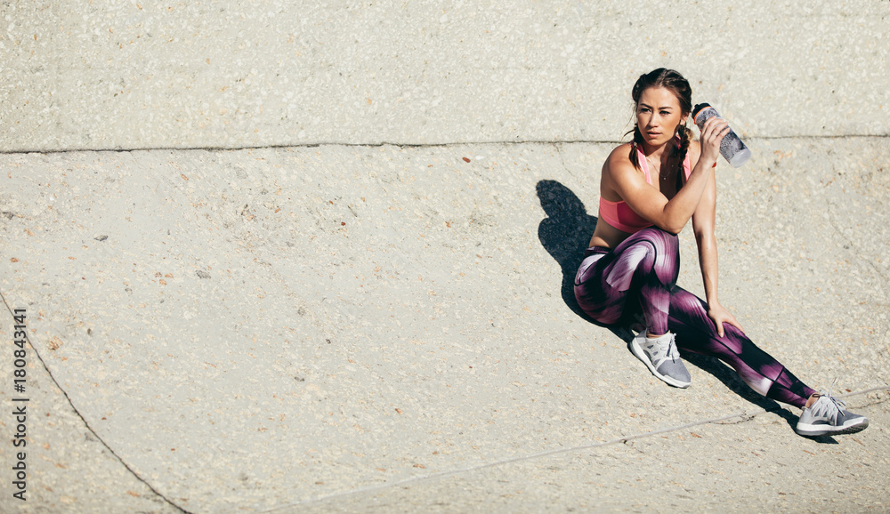 Fitness woman relaxing after workout session