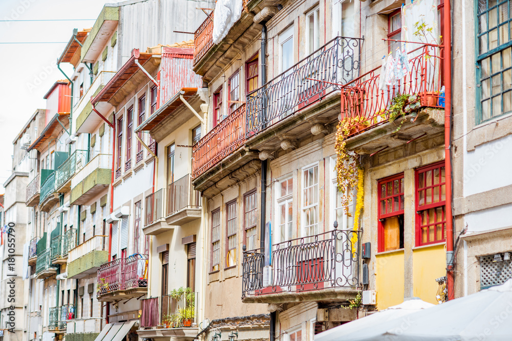 Street view on the beautiful old buildings with portuguese tiles on facades in Porto city, Portugal