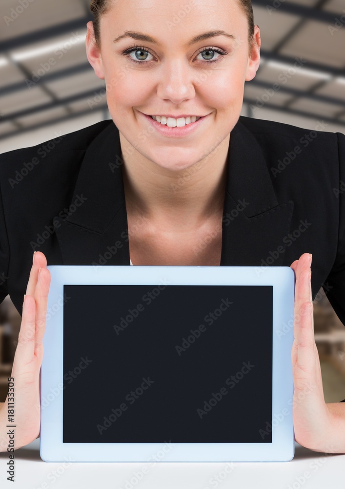 Woman holding tablet with warehousse background