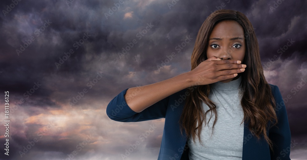 Woman with hand over mouth and dark clouds