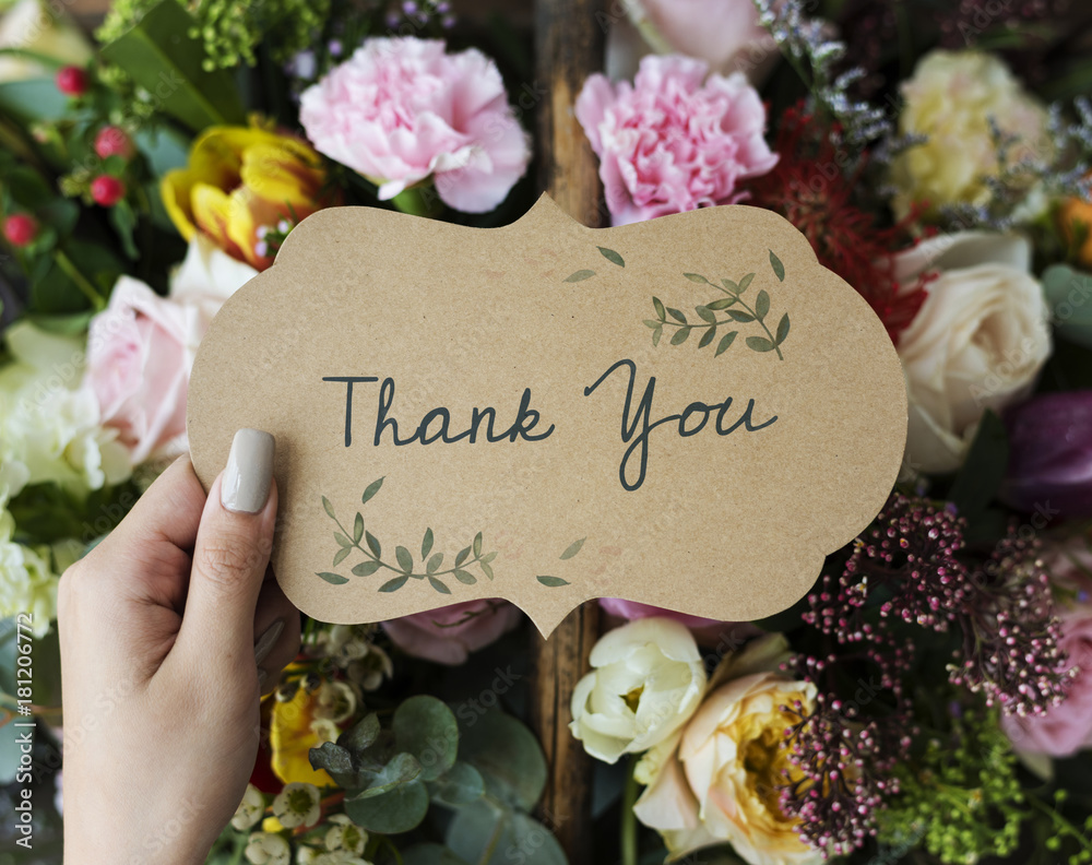 People Hand Holding Thank You Card with Flowers Bouquet Background