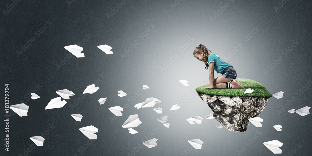 Concept of careless happy childhood with girl and paper planes f