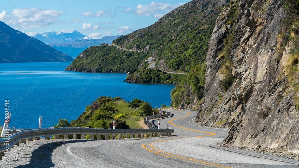 Winding Road along Mountain Cliff and Lake