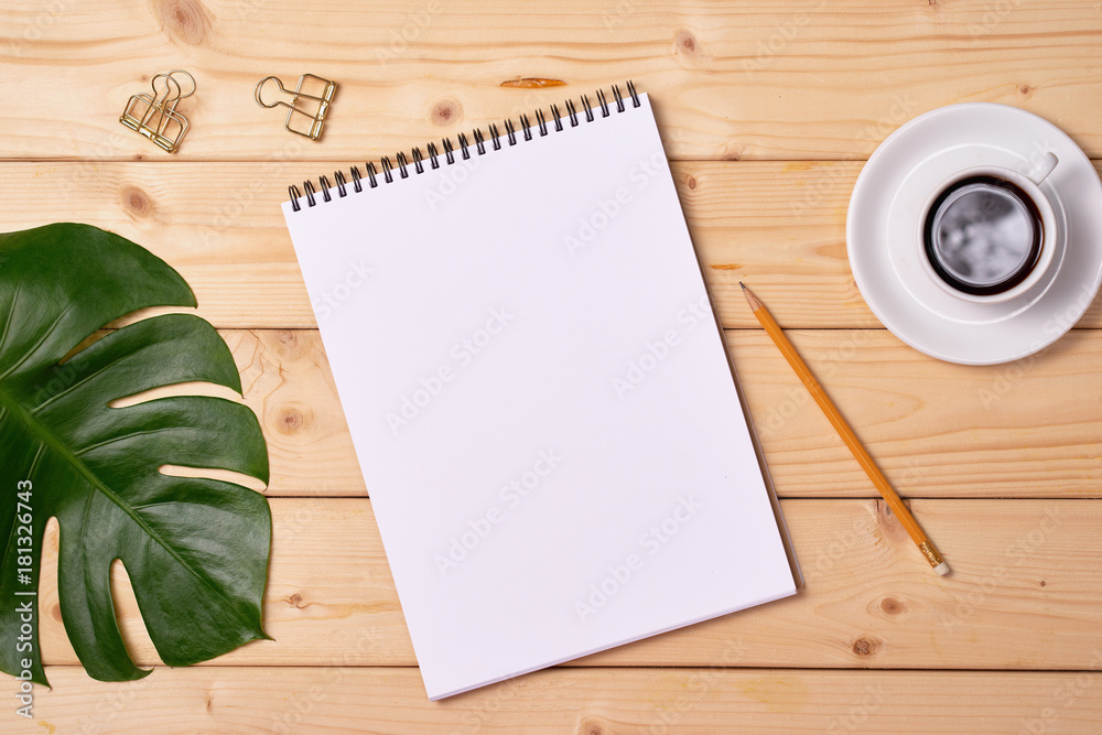 Blank sketchbook on wooden background, free space. Top view.