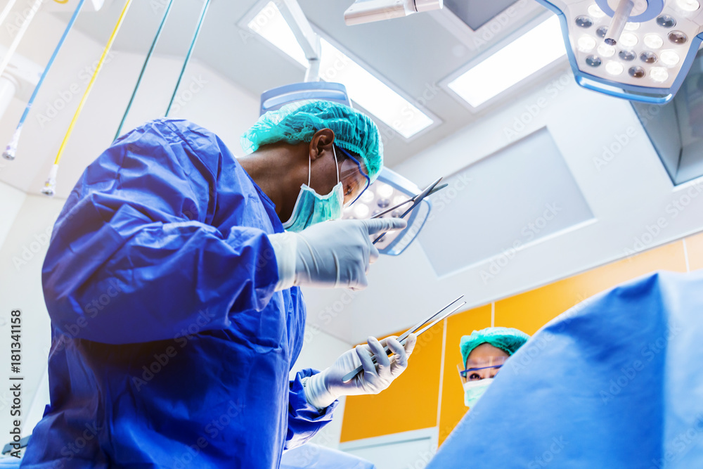 doctor and assistance Medical team performing surgery on a patient with focus and stressful moment