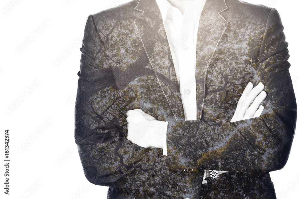 double exposure of businessman in suit and old tree in a green forest view from ground