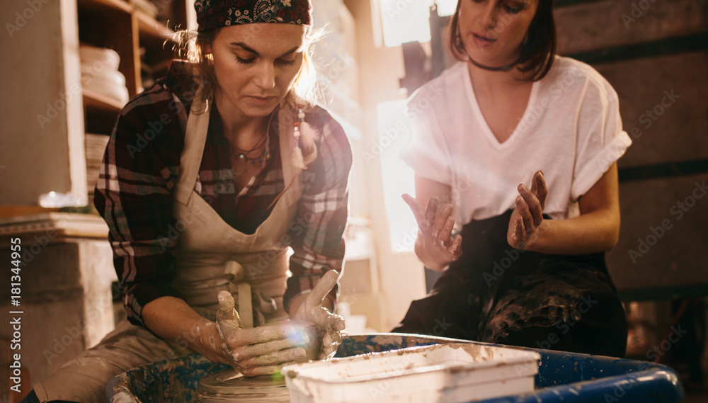 Female potter working on potters wheel