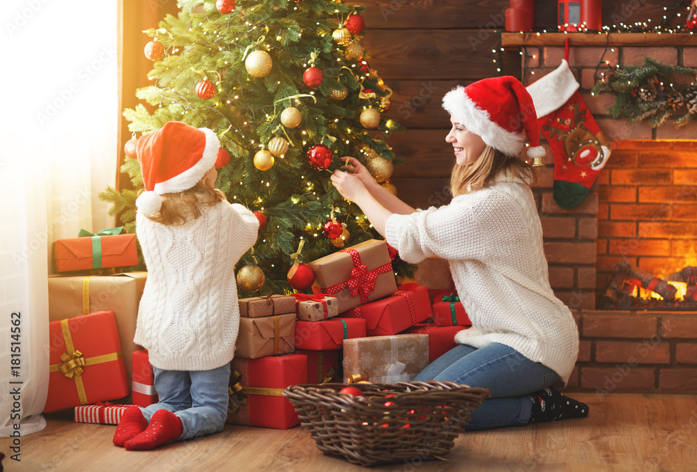 happy family mother and child girl decorated Christmas tree