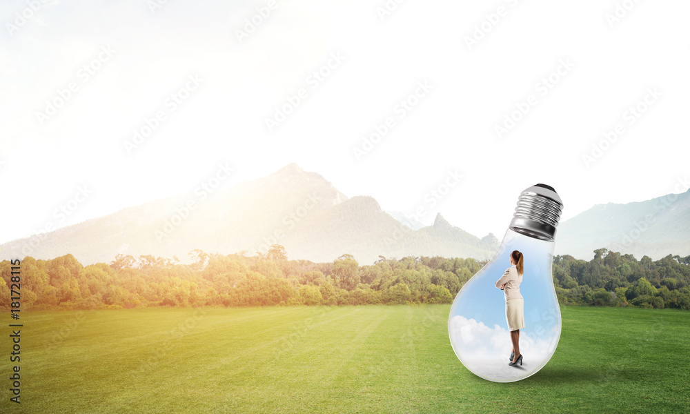 Businesswoman inside light bulb