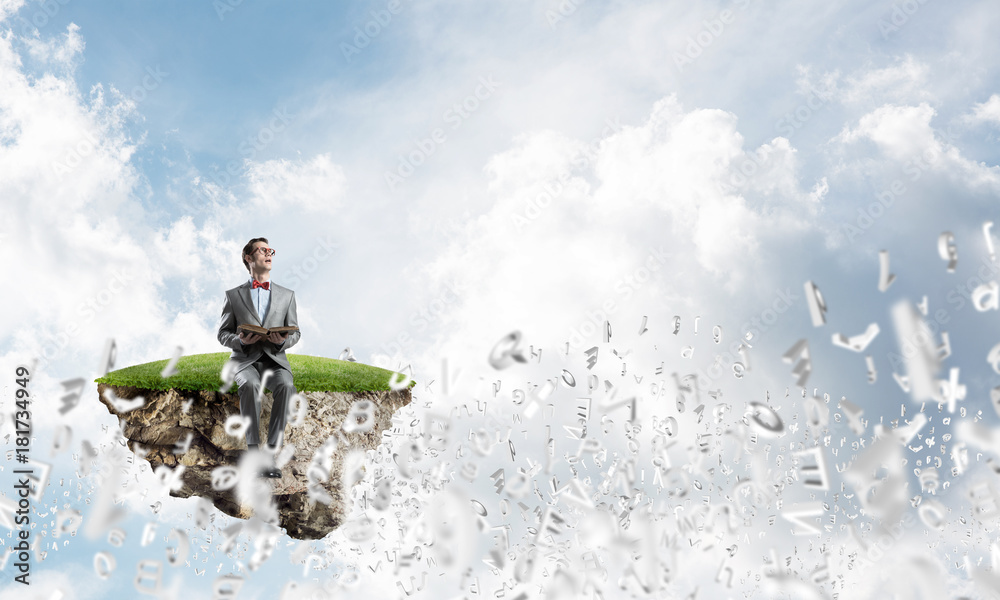 Young businessman or student studying the science and symbols fly around