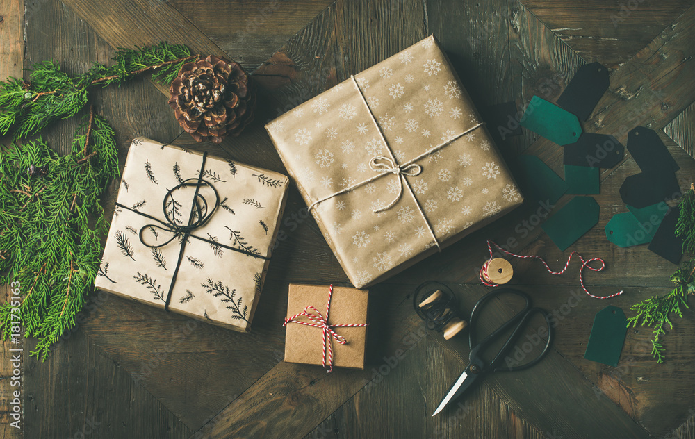 Preparing for Christmas or New Year holiday. Flat-lay of gift boxes, rope, fur branches, pine cones,