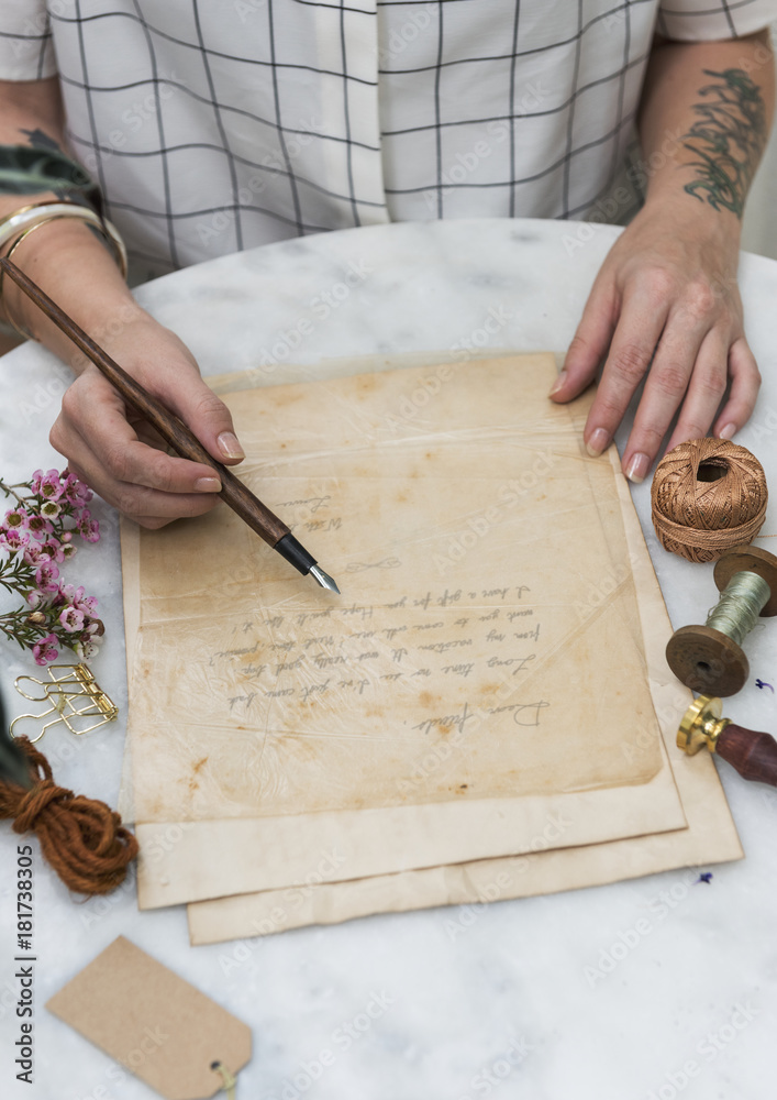 Hands writing a note on a paper