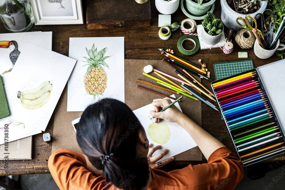 Asian woman is working on her hand drawing artwork