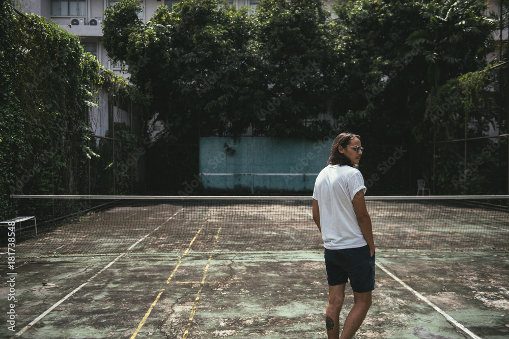 Man standing in a tennis court