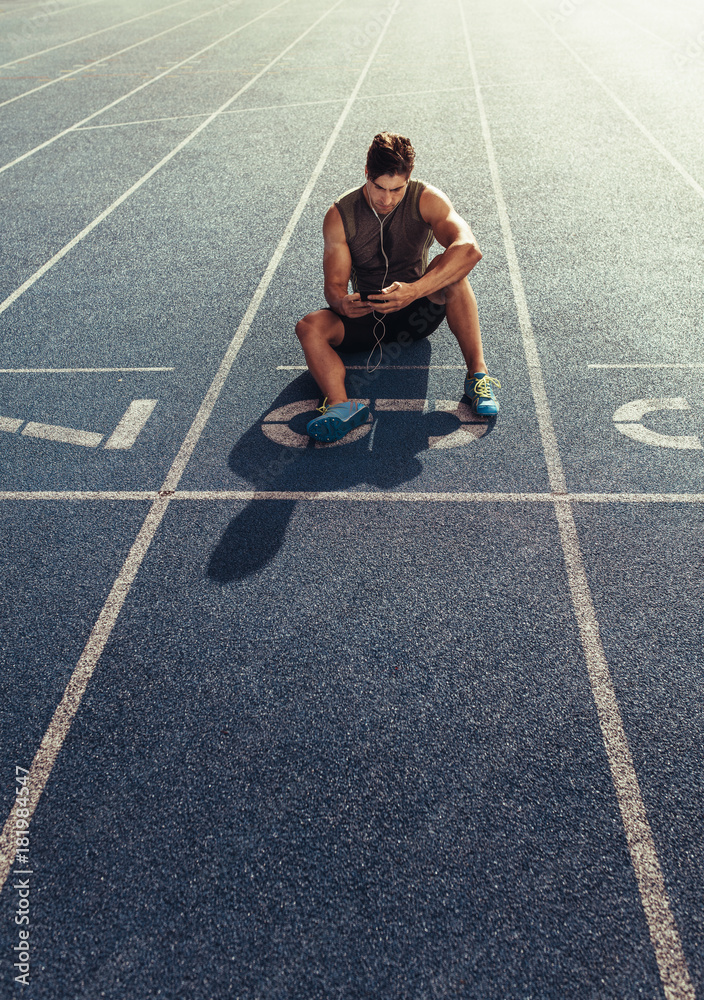 Sprinter relaxing on running track