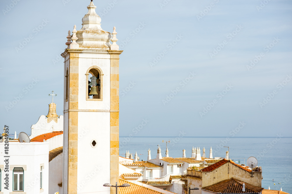 Cityscape view on the old town with beautiful white houses and bell tower in Albufeira city on the s