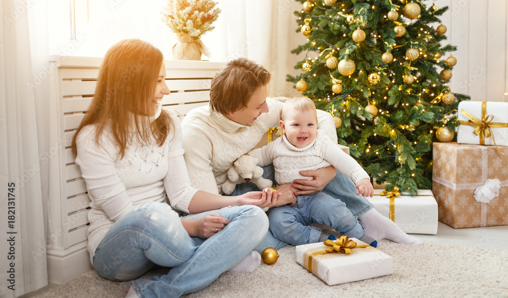 happy family mother and baby in   Christmas morning at   Christmas tree.