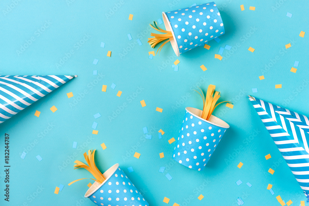 Celebration pattern with various party confetti on blue background. Flat lay