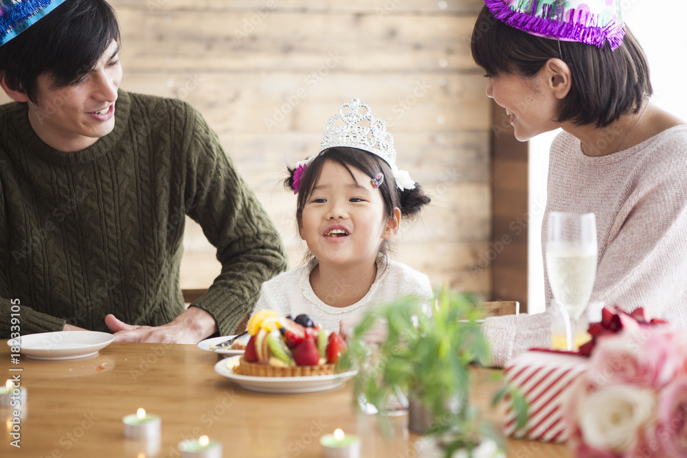 Dad and mommy are celebrating her daughter s birthday.