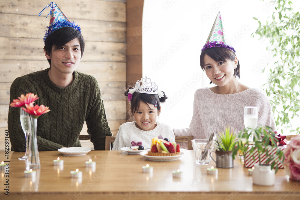 Dad and mommy are celebrating her daughter s birthday.