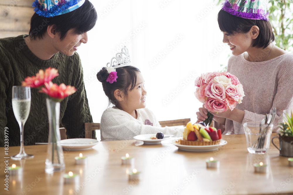 Dad and mommy give birthday present to her daughter.