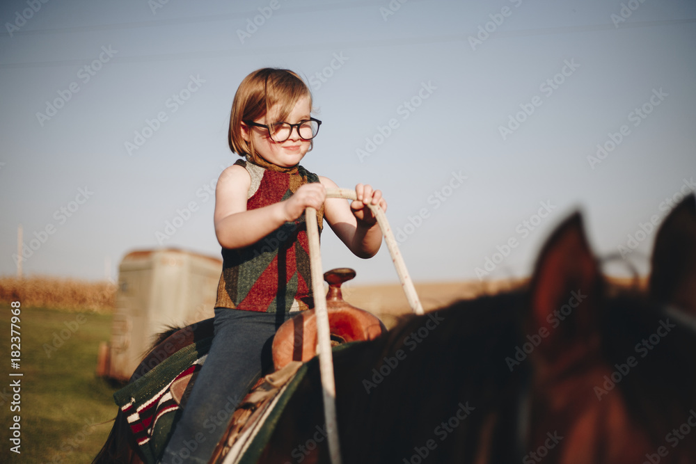 Young girl is enjoying a horse riding