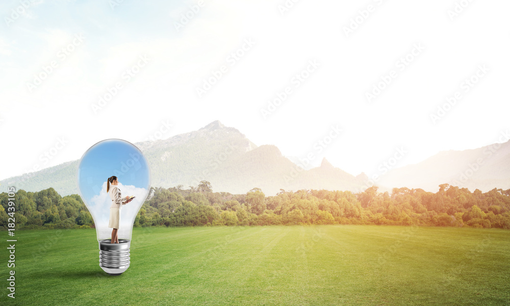 Businesswoman inside light bulb