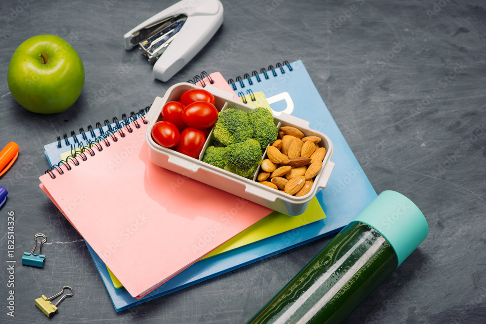 Lunch box with vegetables for a healthy school lunch on wooden table