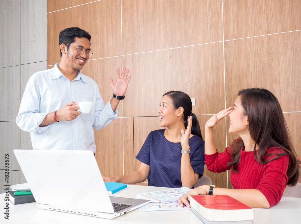 Group of asian business people say hi/good bye each other in the morning in office, good morning, sa