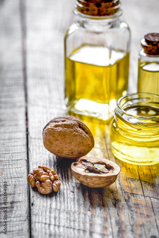 cosmetic and therapeutic walnut oil on wooden background