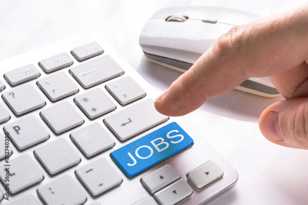 Finger pressing computer button with jobs sign